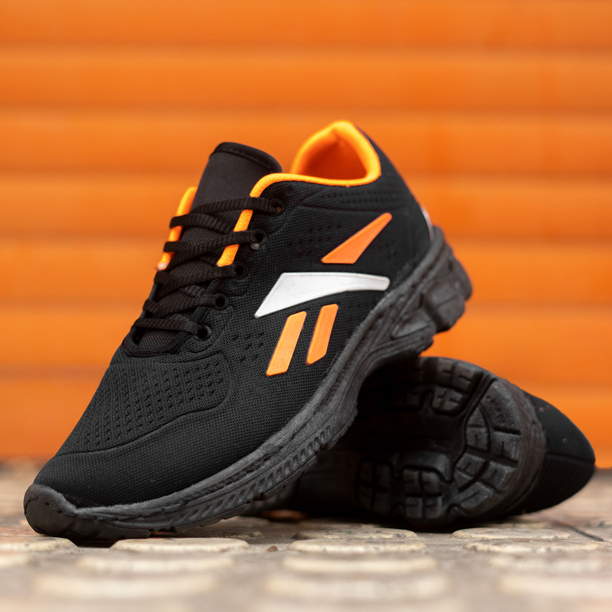 کفش ورزشی (T) ریبوک مشکی نارنجی مردانه مدل adena